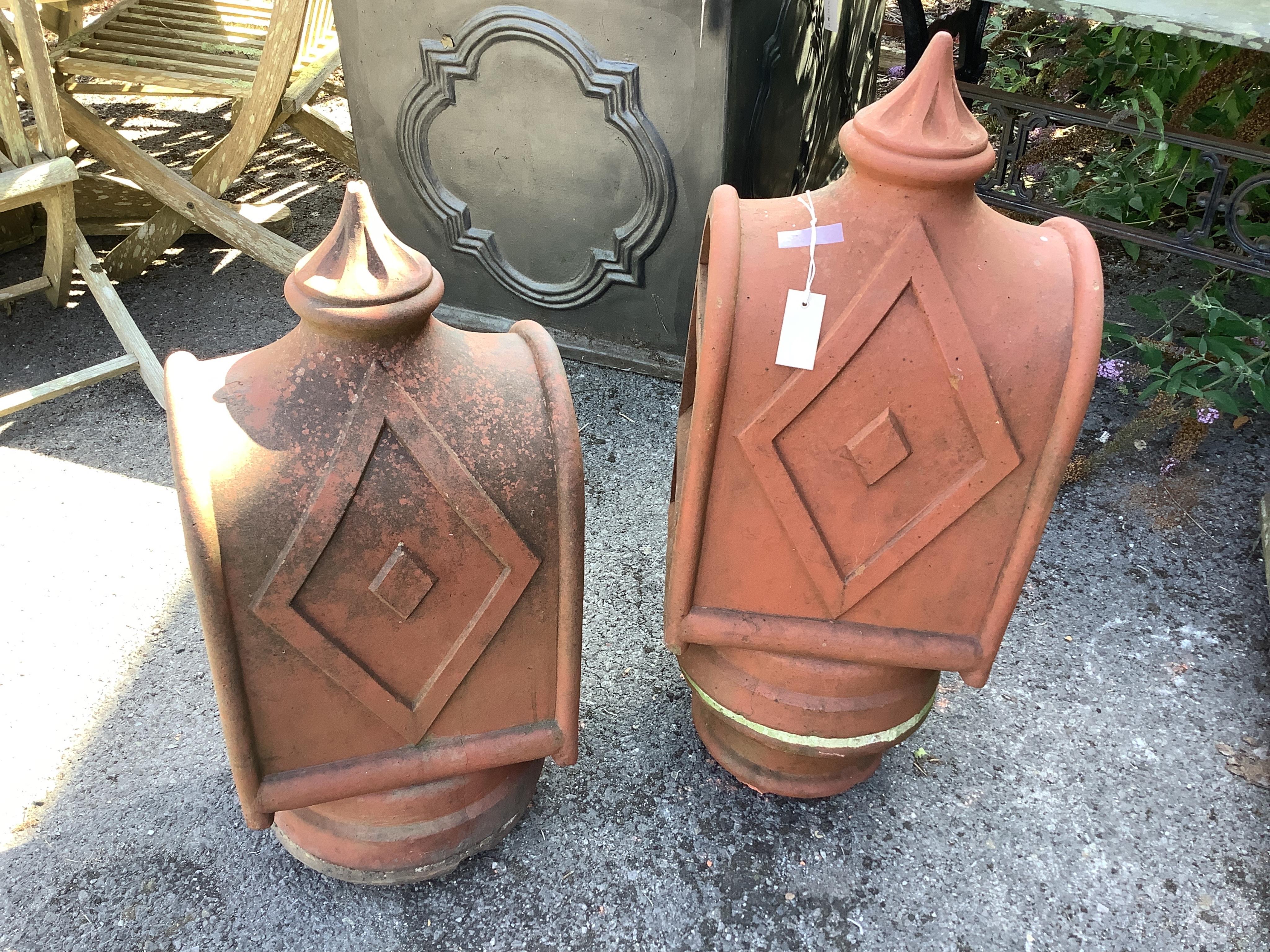 A pair of unusual terracotta chimney cowls, larger height 90cm. Condition - good